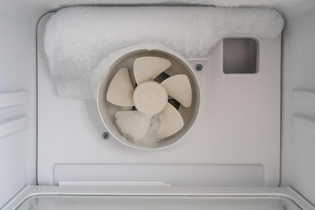 A Samsung freezer fan motor covered in ice, causing the FF error code.