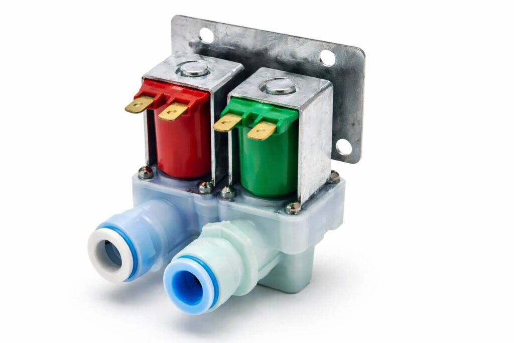 Preparing for a Whirlpool water valve replacement at the back of the refrigerator.