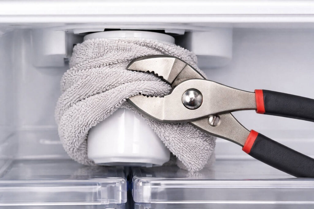 using-pliers-to-remove-stuck-refrigerator-water-filter